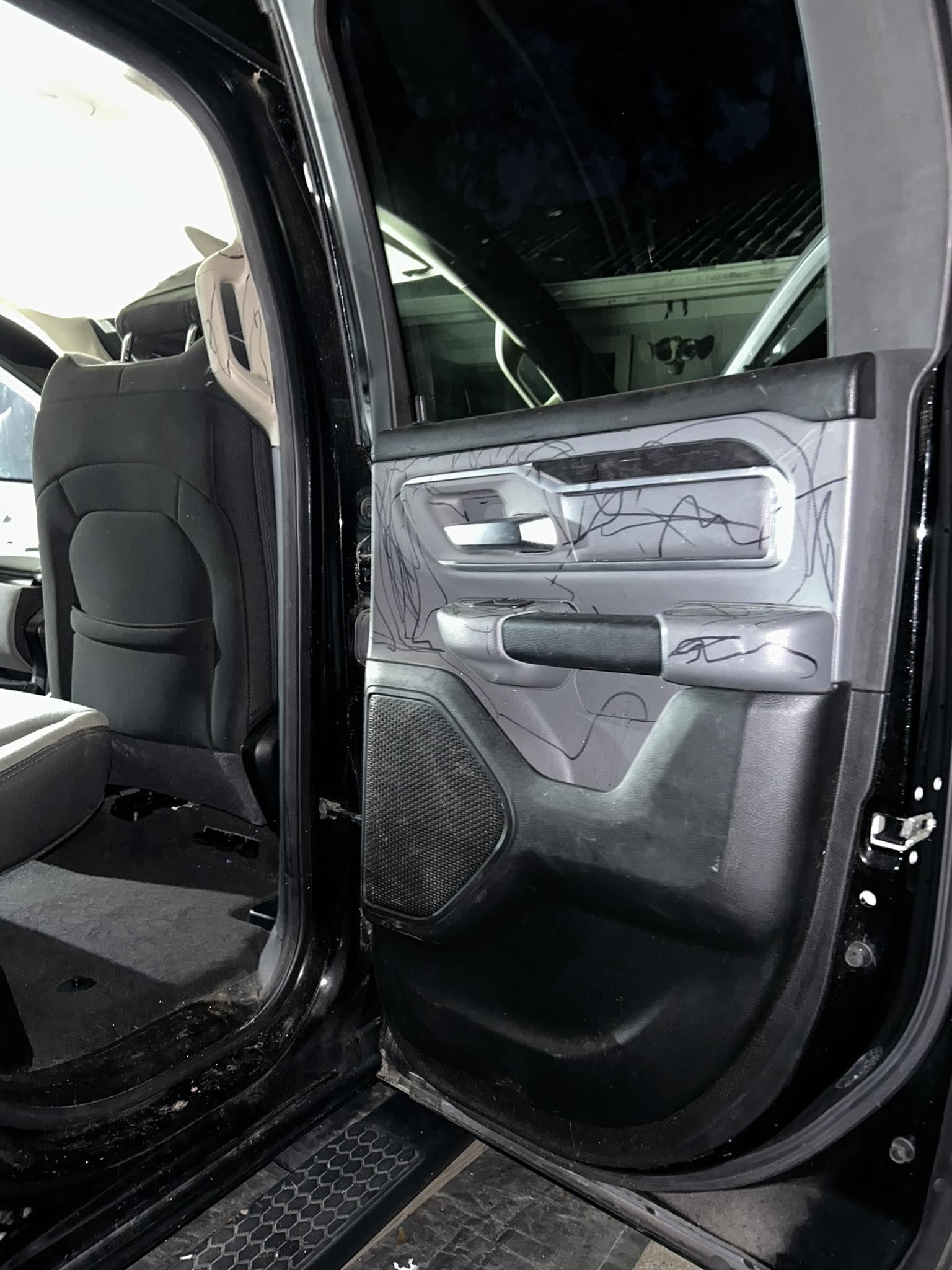 Truck door panel covered in pen marks before detailing